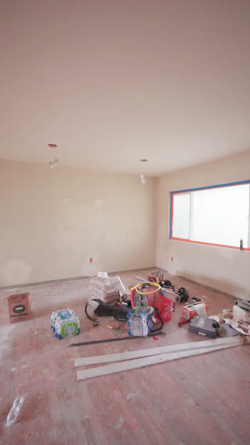Drywalled room stacked with materials